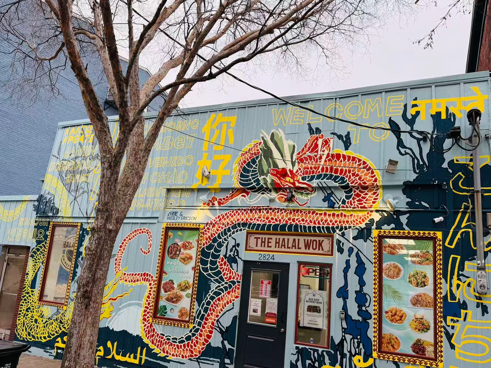 Colorful restaurant exterior with dragon mural and diverse greetings