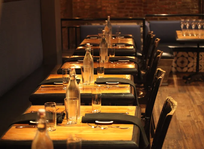 Cozy restaurant interior with wooden tables and elegant glassware