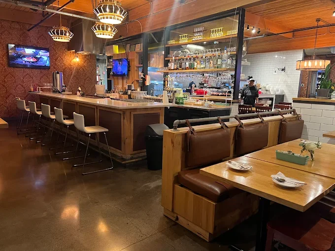 Cozy restaurant interior with a modern bar and warm lighting
