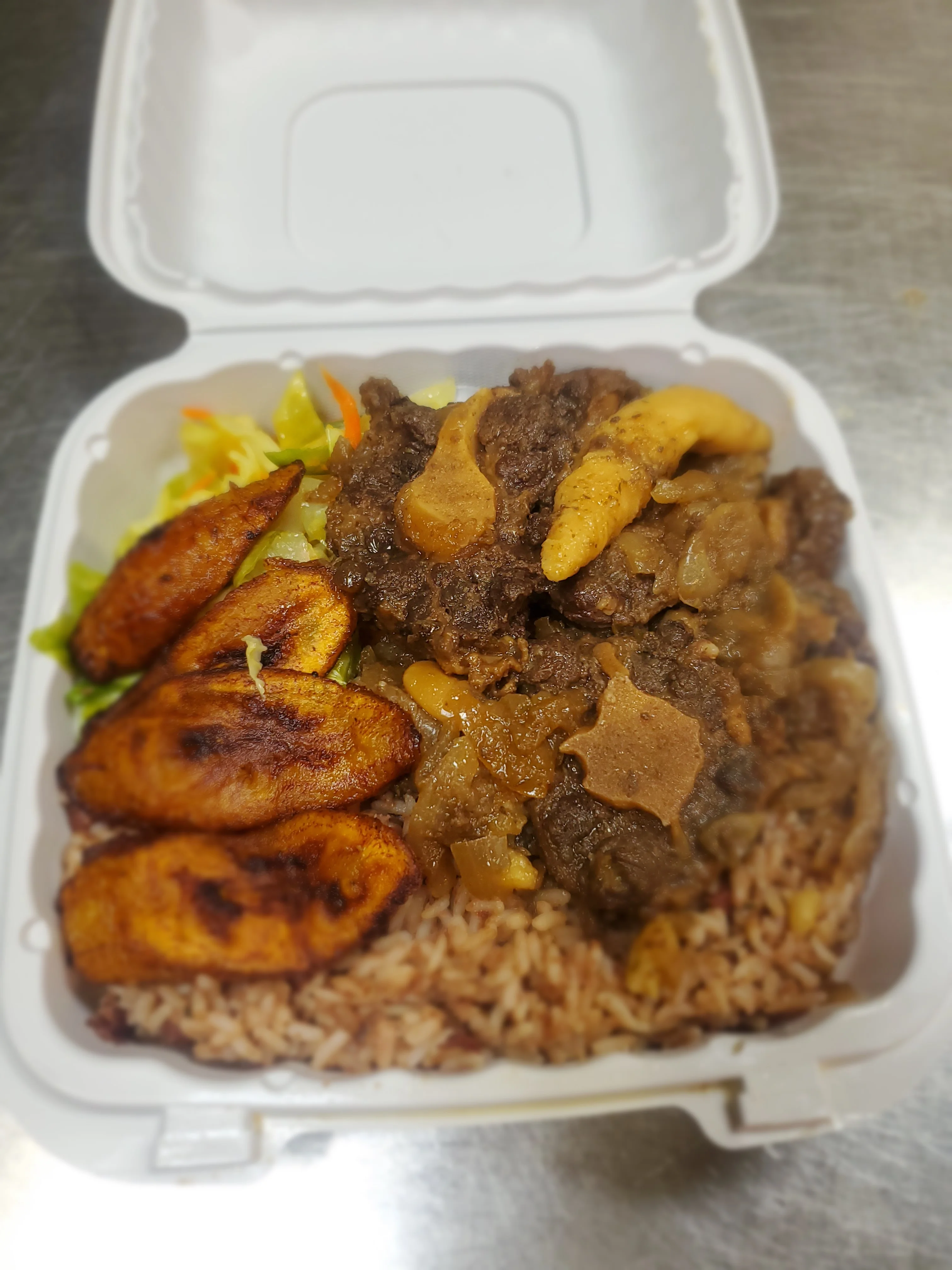 Jamaican oxtail stew with rice and plantains