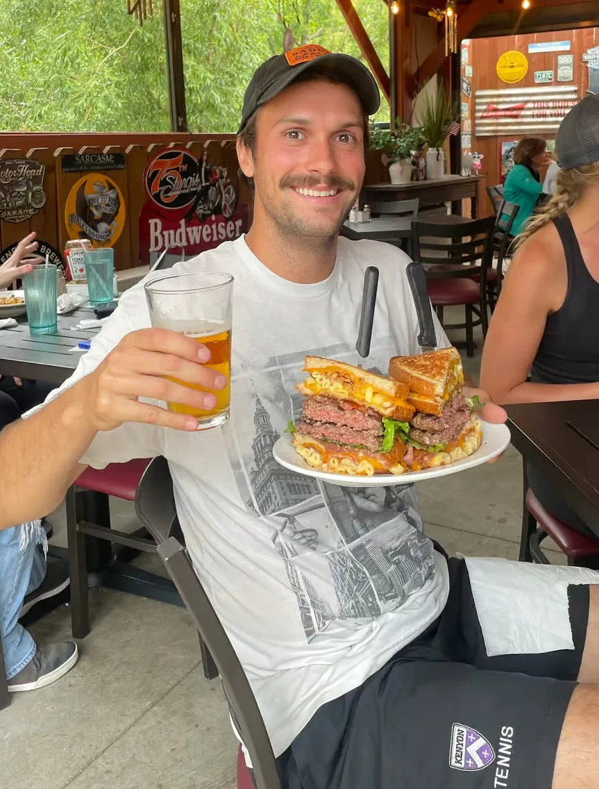 Giant cheeseburger with fries in a casual dining setting