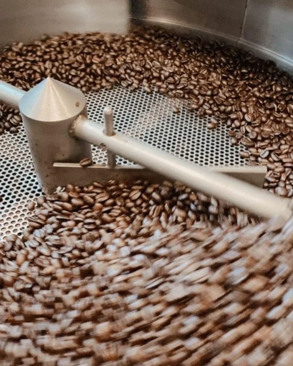 Coffee beans roasting in a commercial roaster