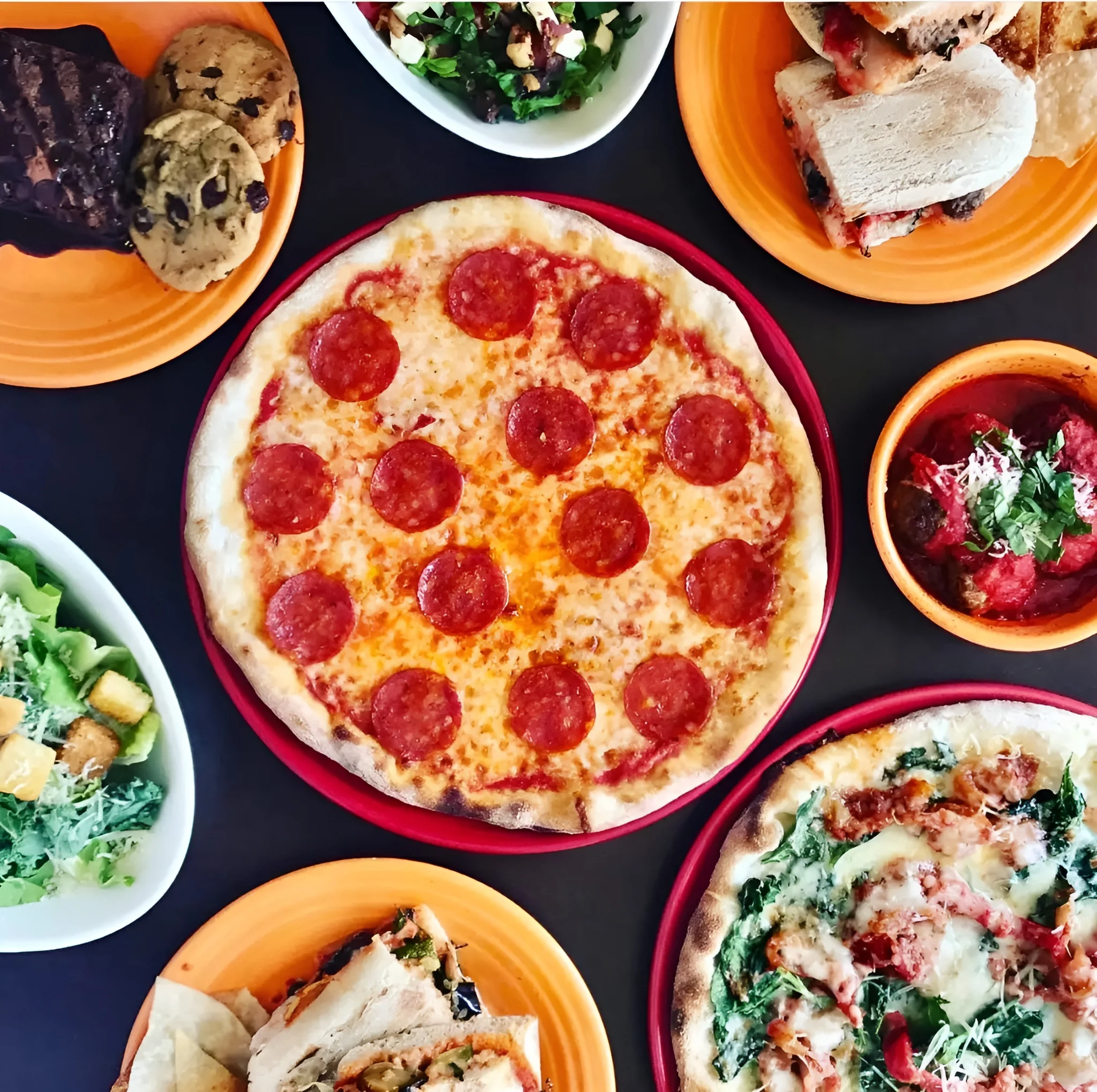 Assorted pizzas and salads in a vibrant restaurant setting
