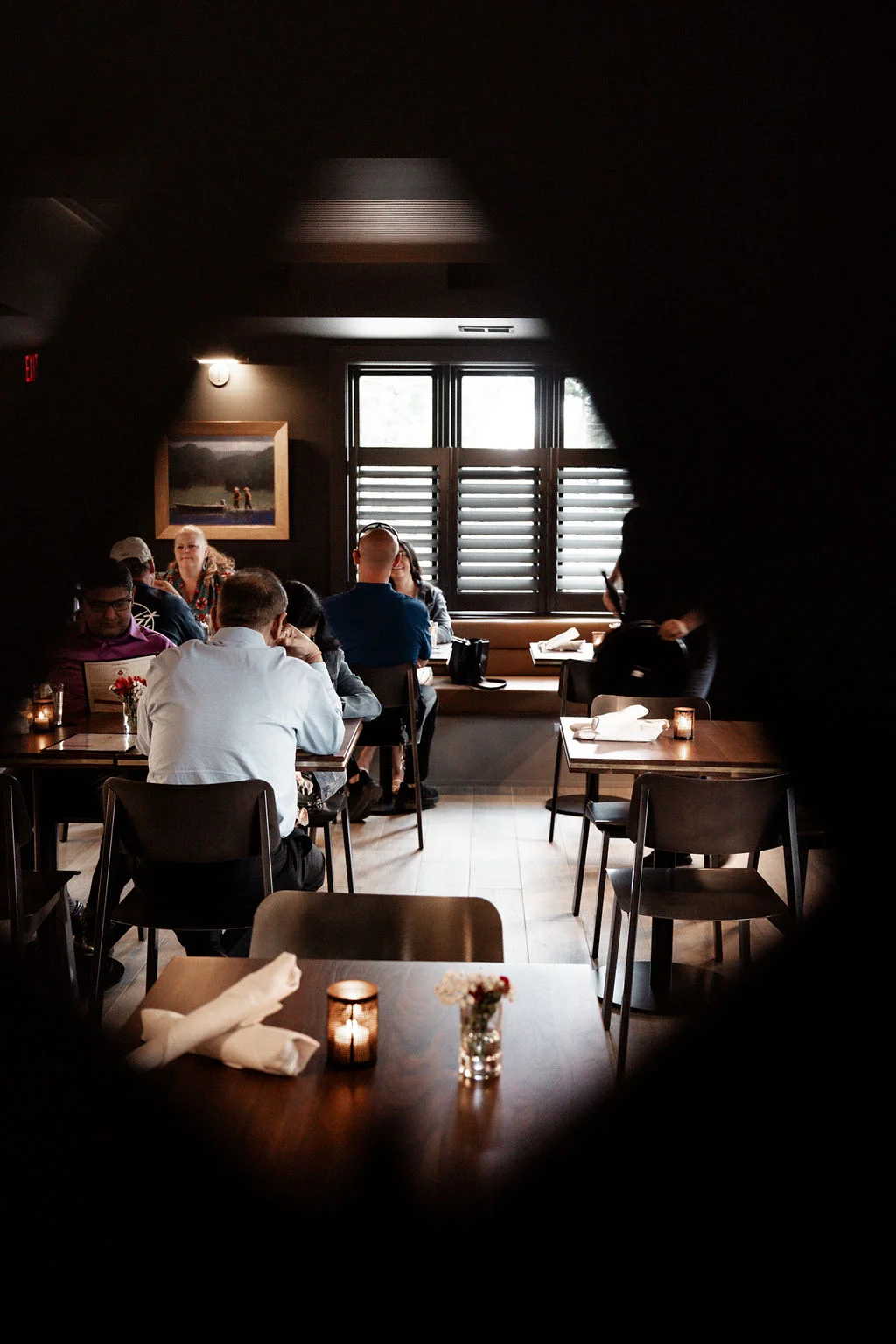 Guests at dinner in the Firetender dining room inside Hotel Manteo