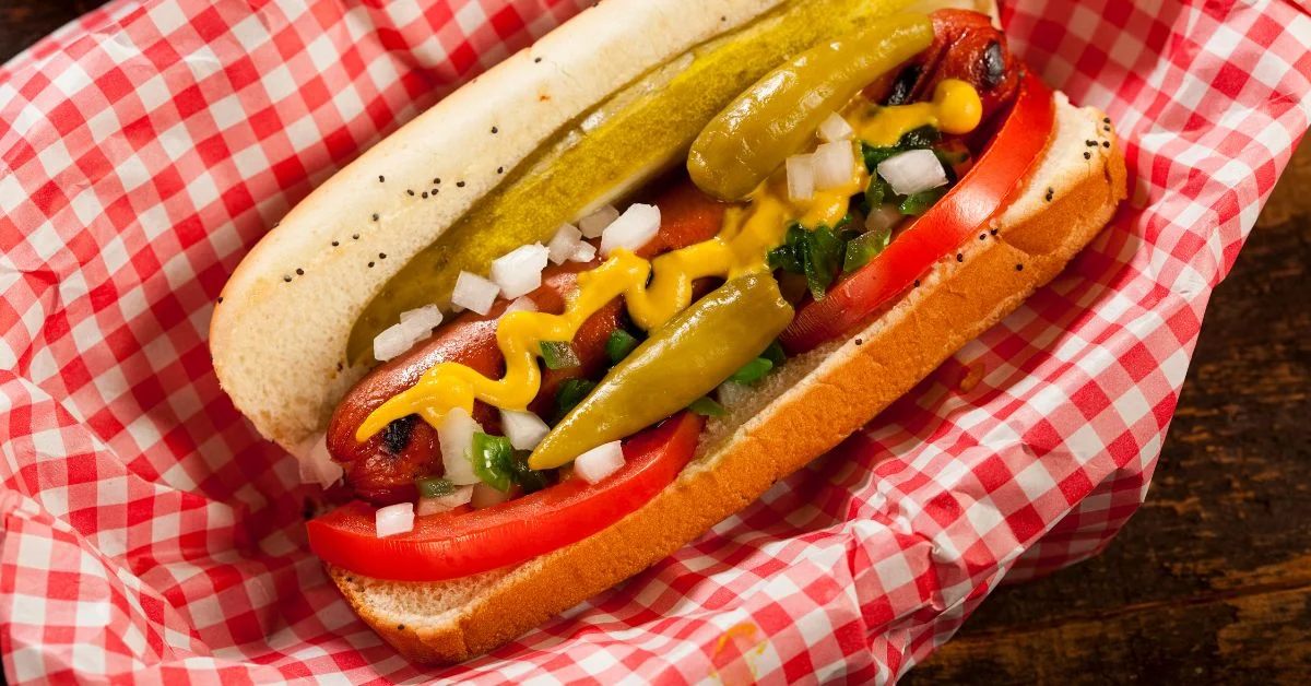 Classic American hot dog with toppings in a checkered basket