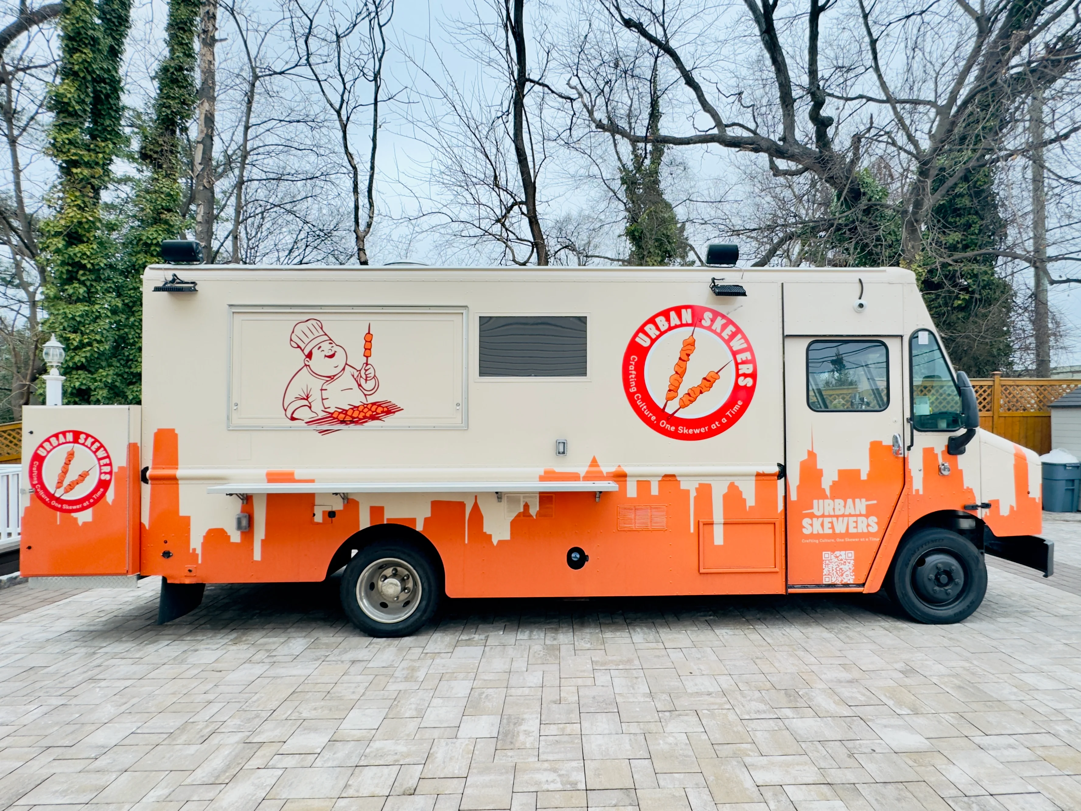 Urban food truck serving skewers in a vibrant city setting