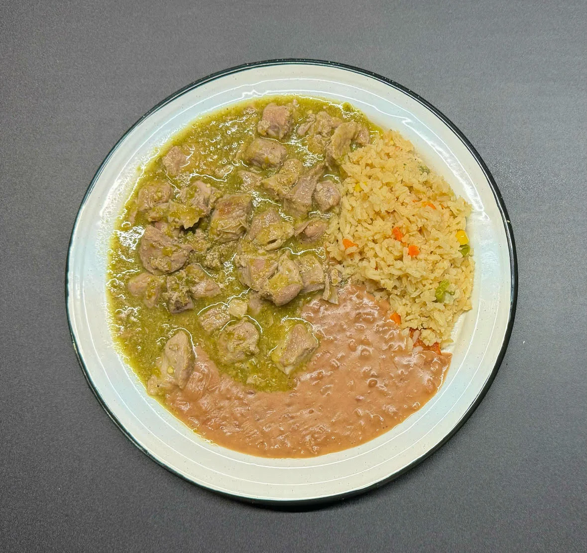 Mexican carne de res in green sauce with rice and beans