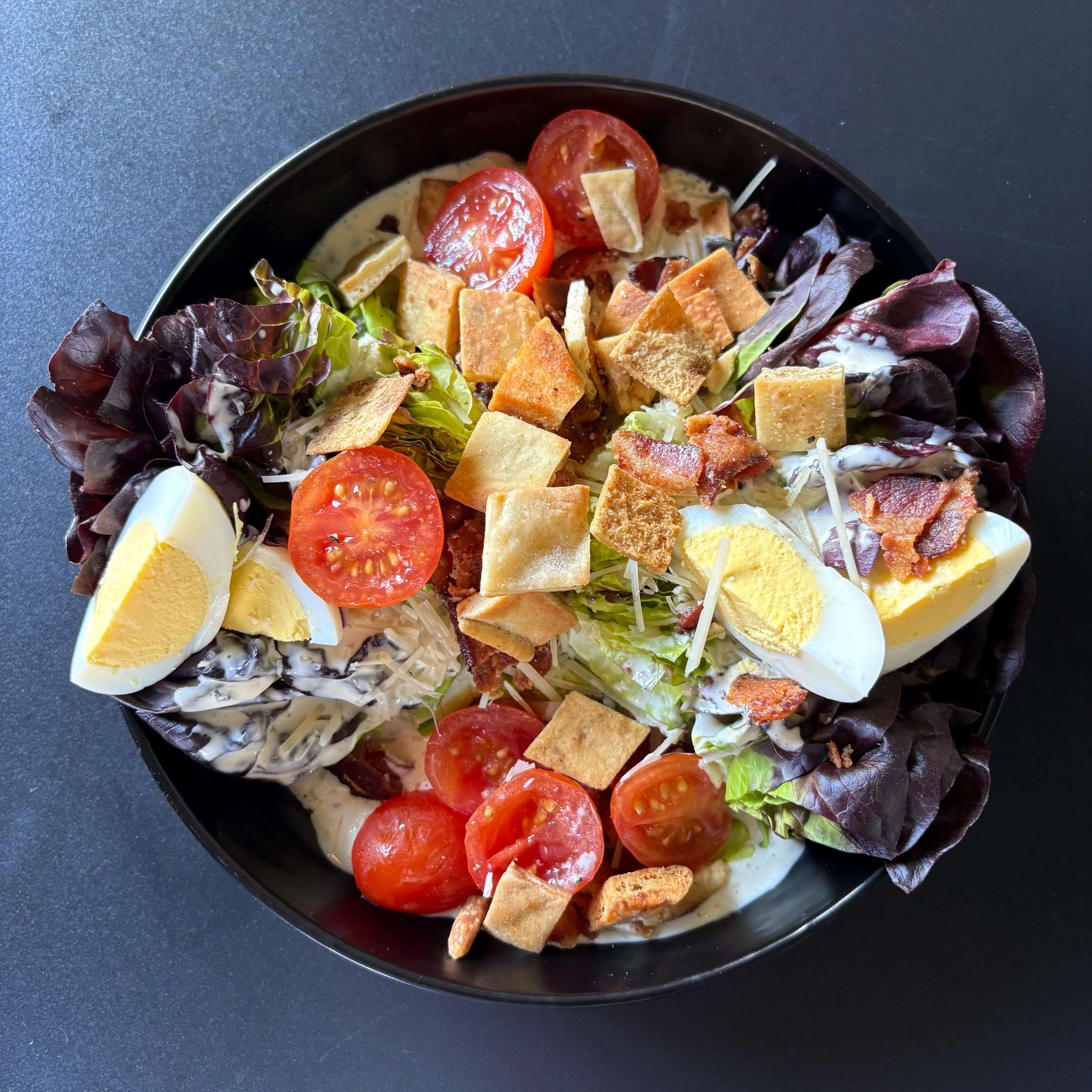 Classic Caesar salad with crispy toppings and hard-boiled eggs