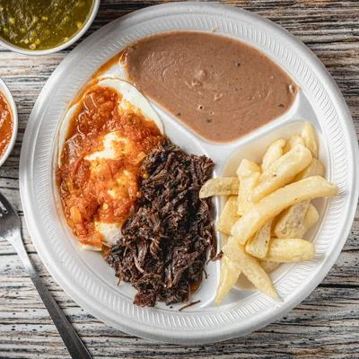 A plate of Mexican food and fries
