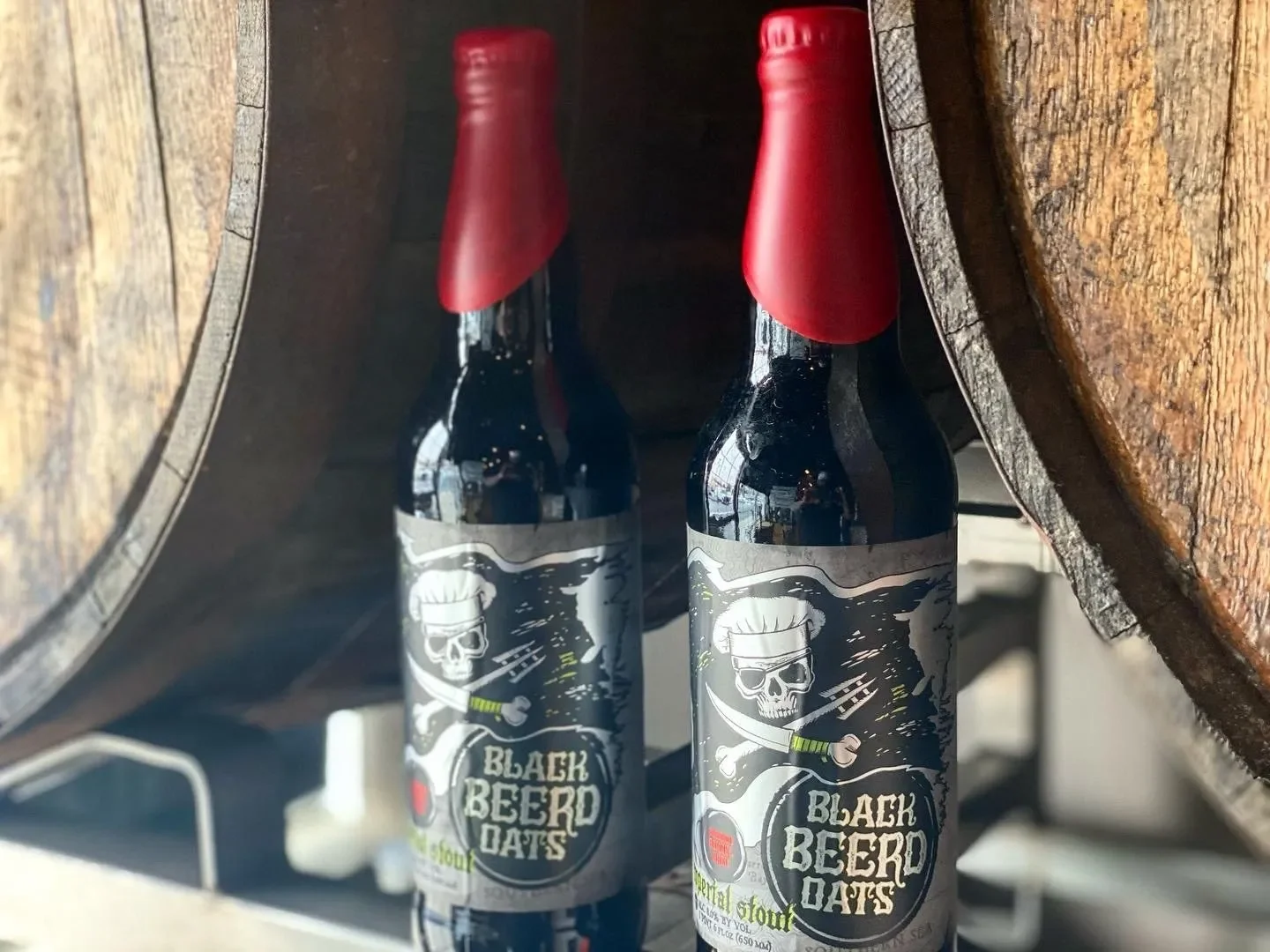 Craft beer bottles of Black Beer Oats stout in a rustic setting