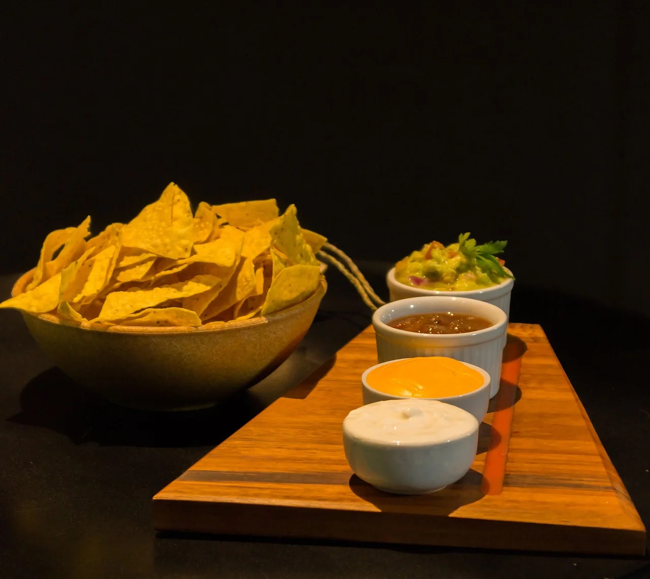 Crispy tortilla chips with guacamole and dips