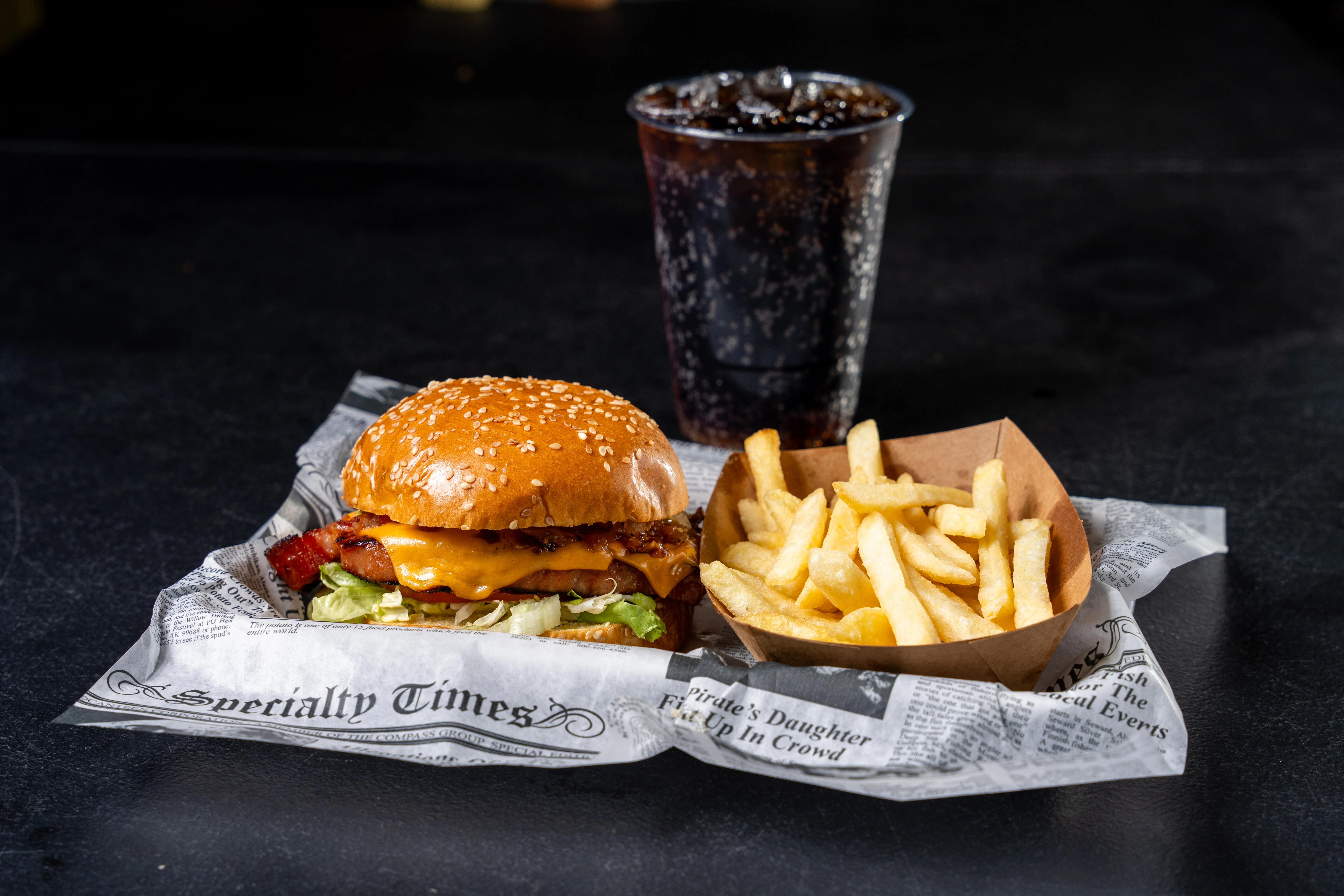 Classic American cheeseburger with fries and soda