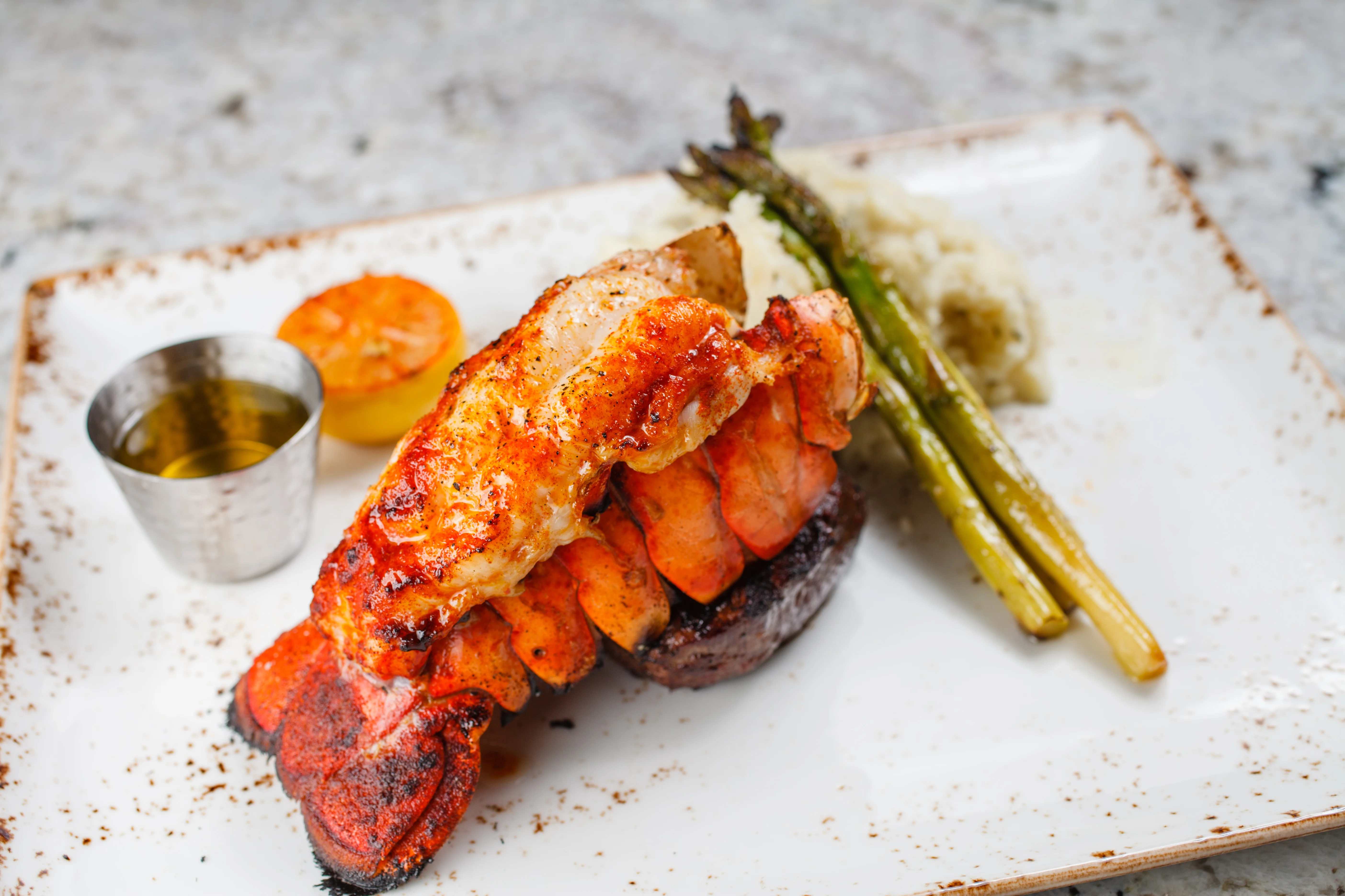 Grilled lobster tail with asparagus and lemon