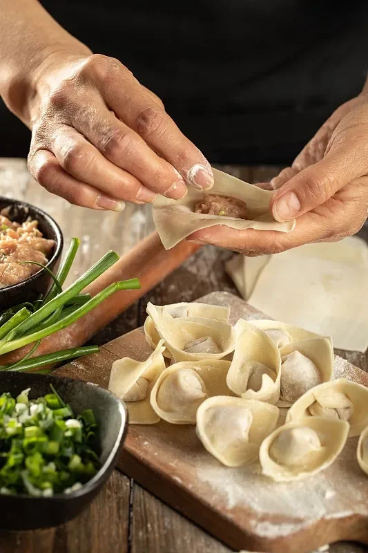 Handmade Chinese dumplings being prepared