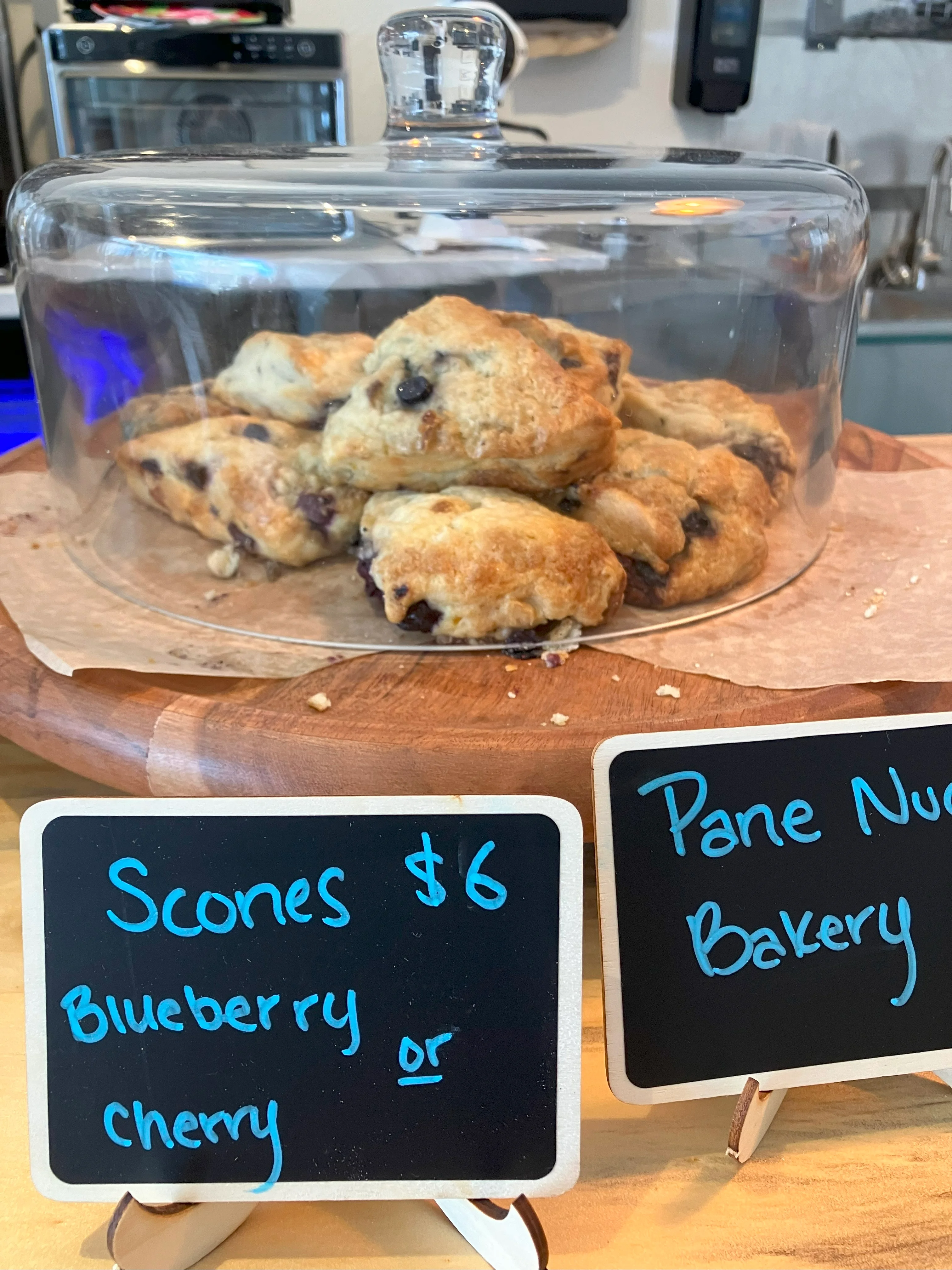 Freshly baked blueberry scones in a bakery display