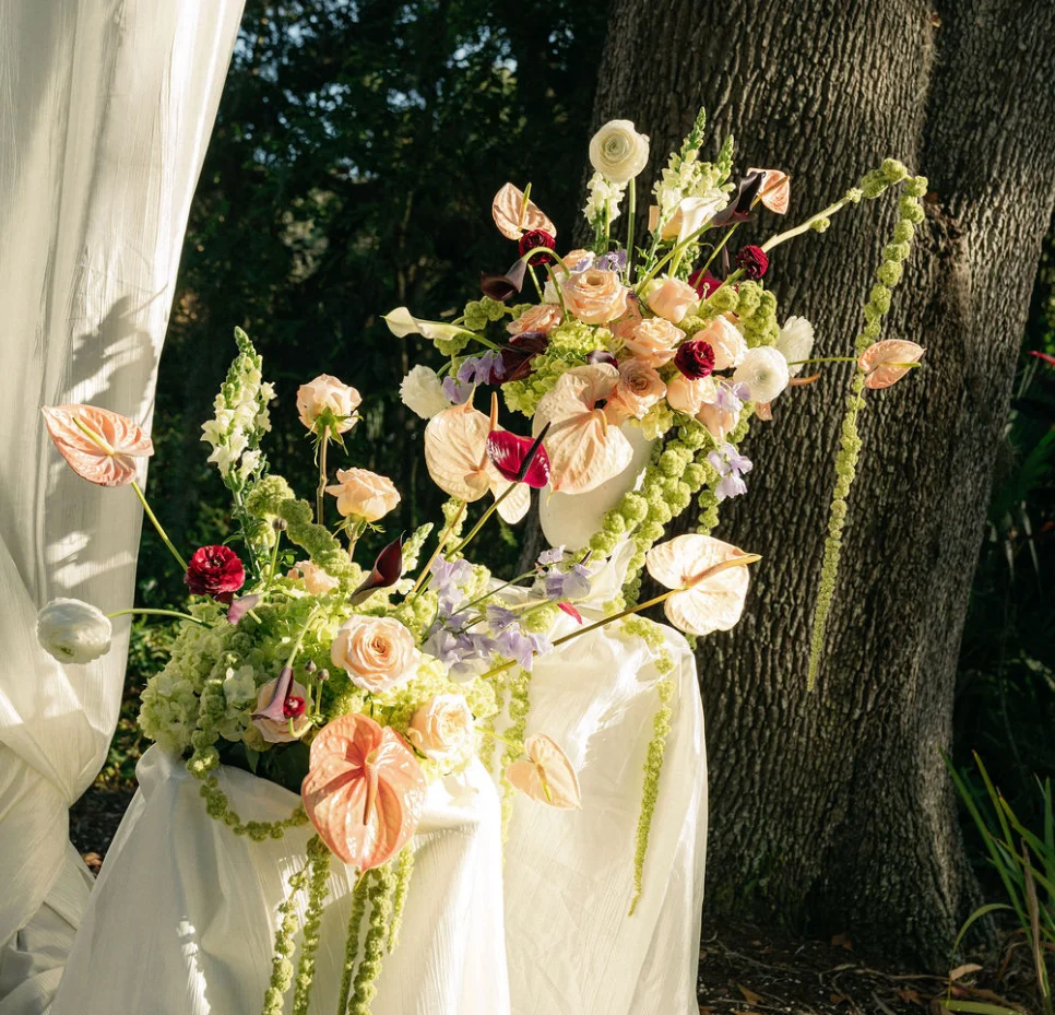 Elegant floral arrangement with pastel blooms and greenery
