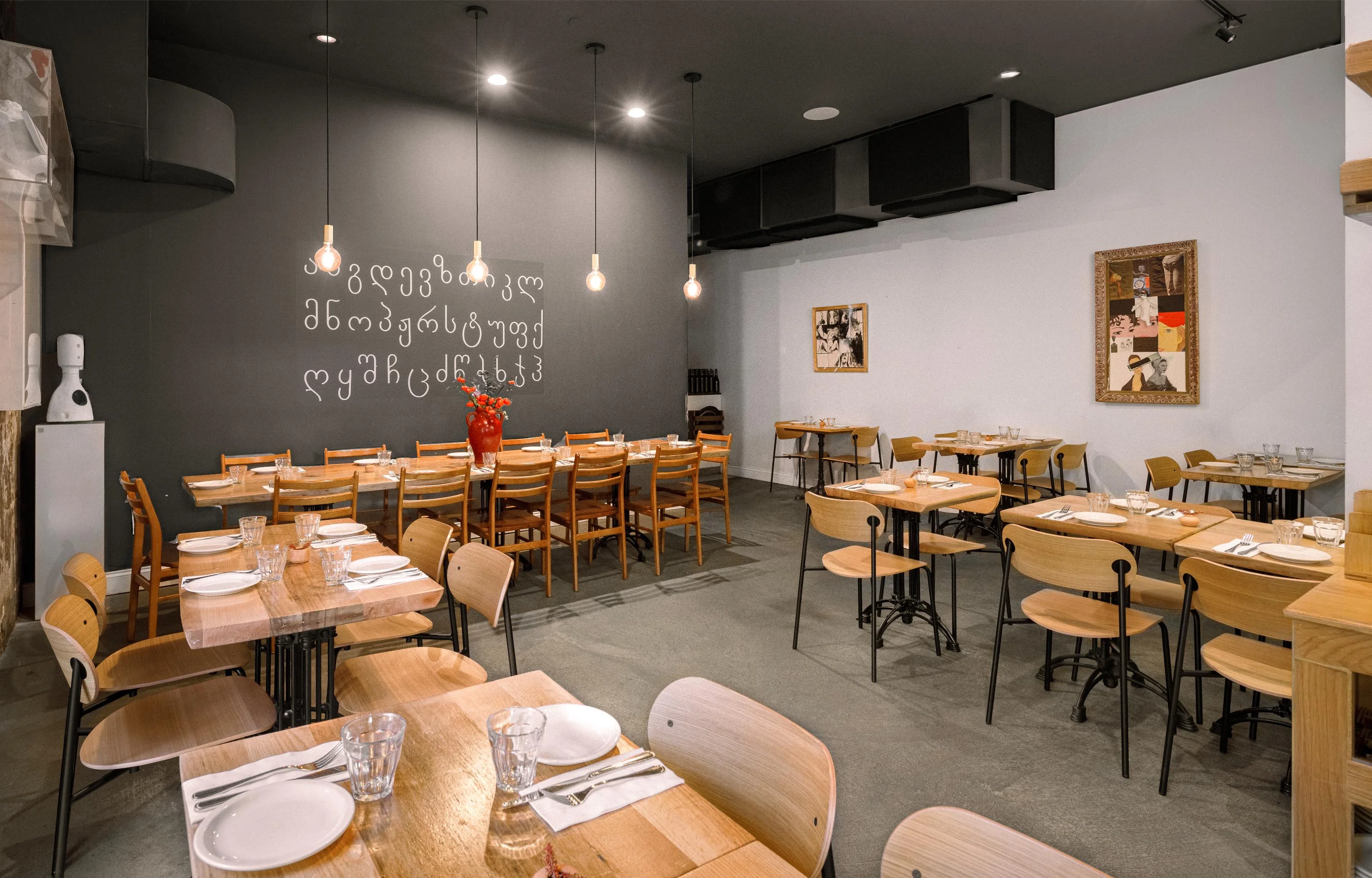 Modern restaurant interior with wooden tables and artistic decor