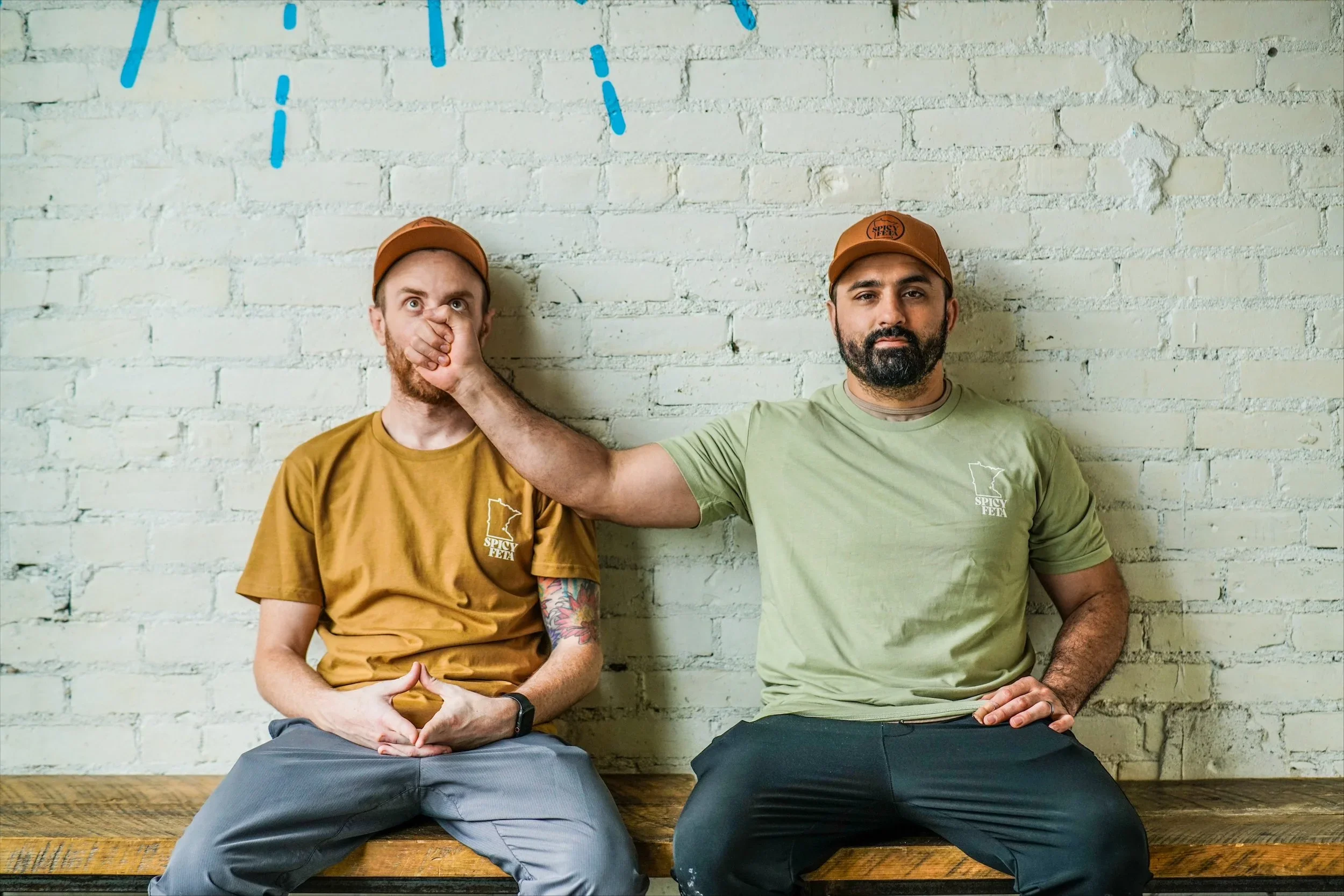 Two men posing playfully in a modern restaurant setting