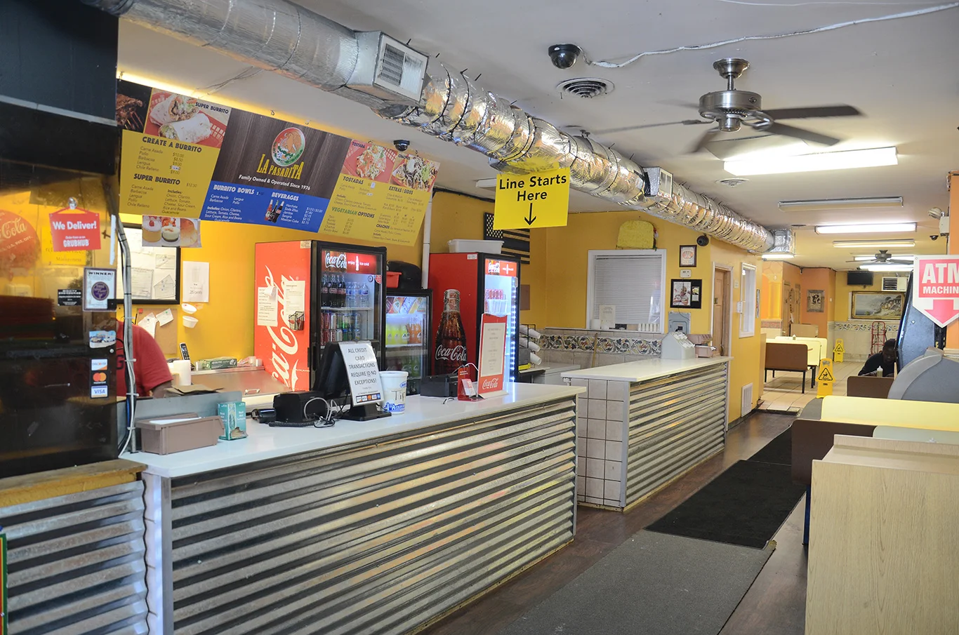 Cozy restaurant interior with colorful menu and counter service