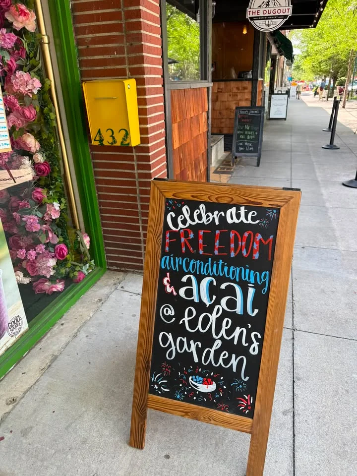 Chalkboard sign promoting acai bowls at Eden's Garden restaurant
