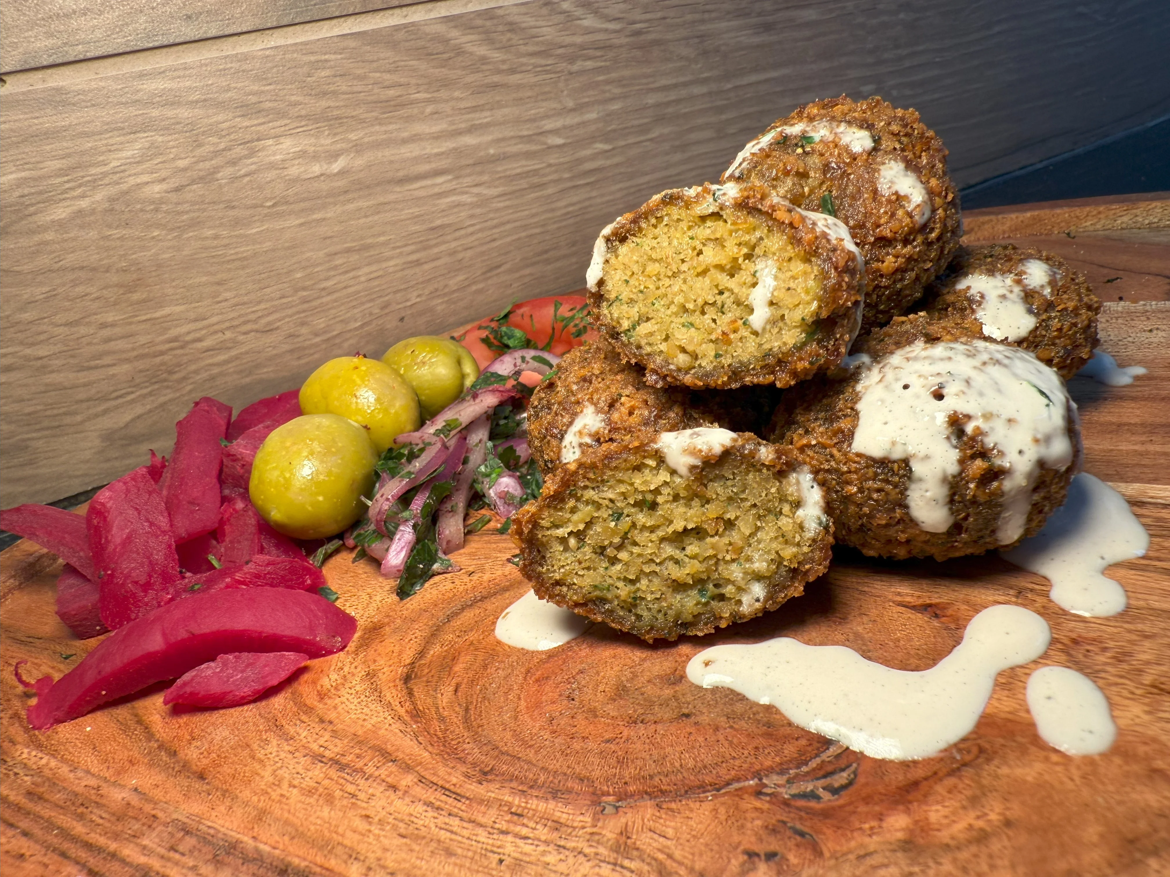 Crispy falafel served with pickled vegetables and tahini sauce