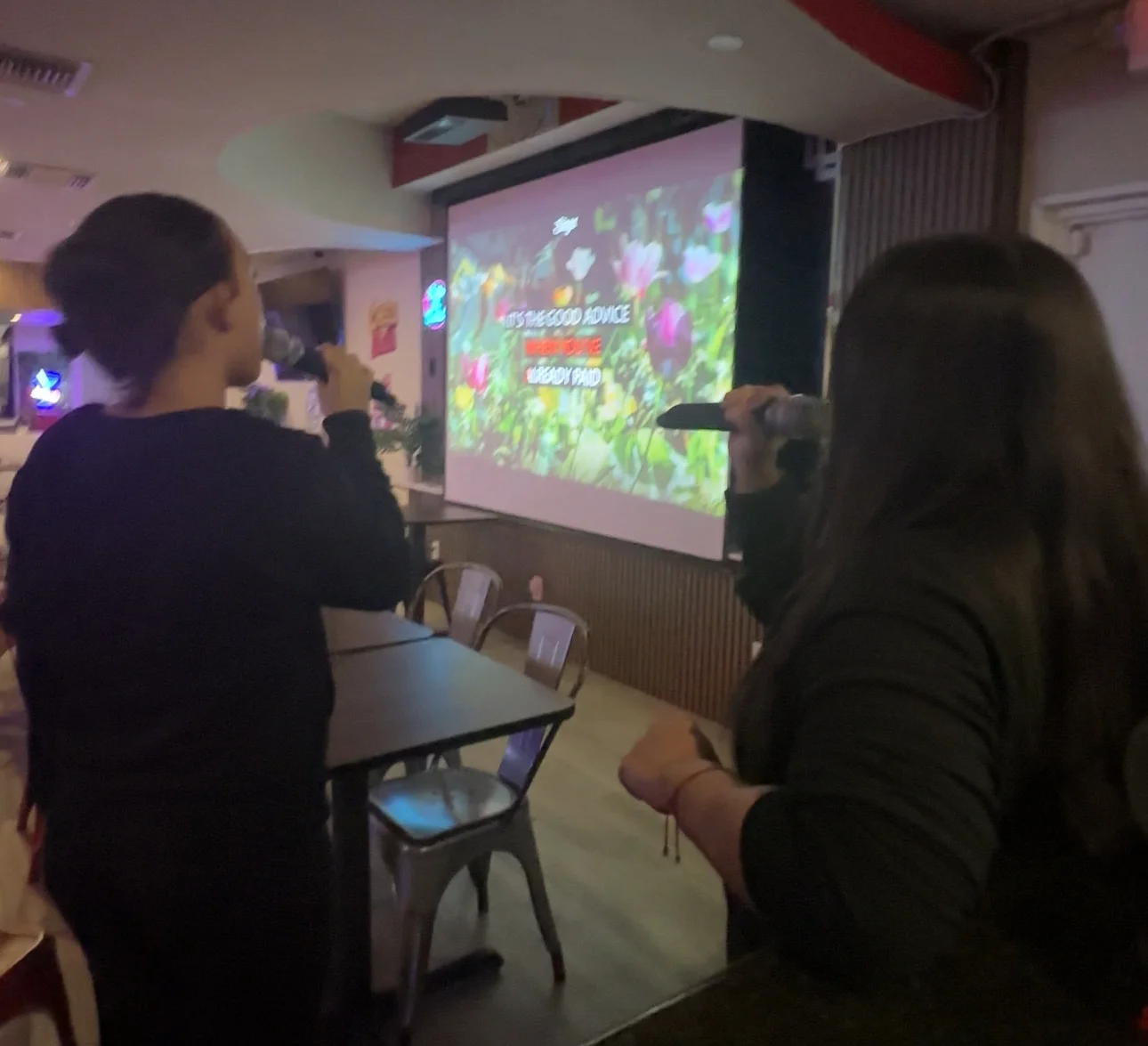 Karaoke night at a lively restaurant with friends singing