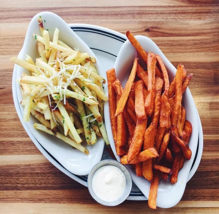Crispy French fries and sweet potato fries served with dipping sauce