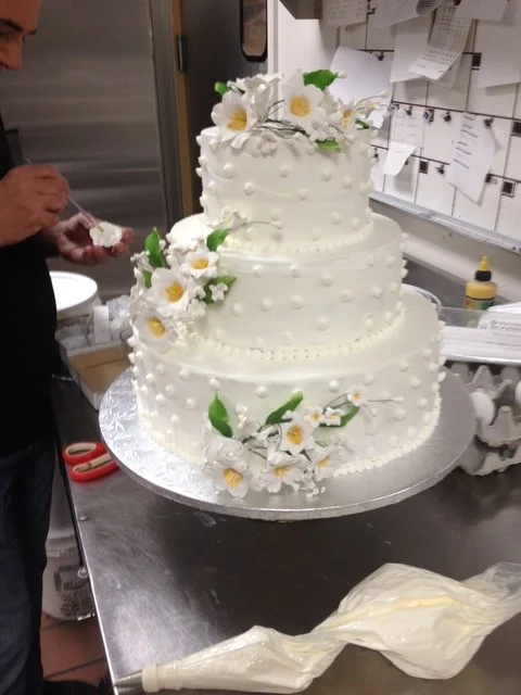 Tiered white wedding cake with sugar flowers from The Kosher Pastry Oven