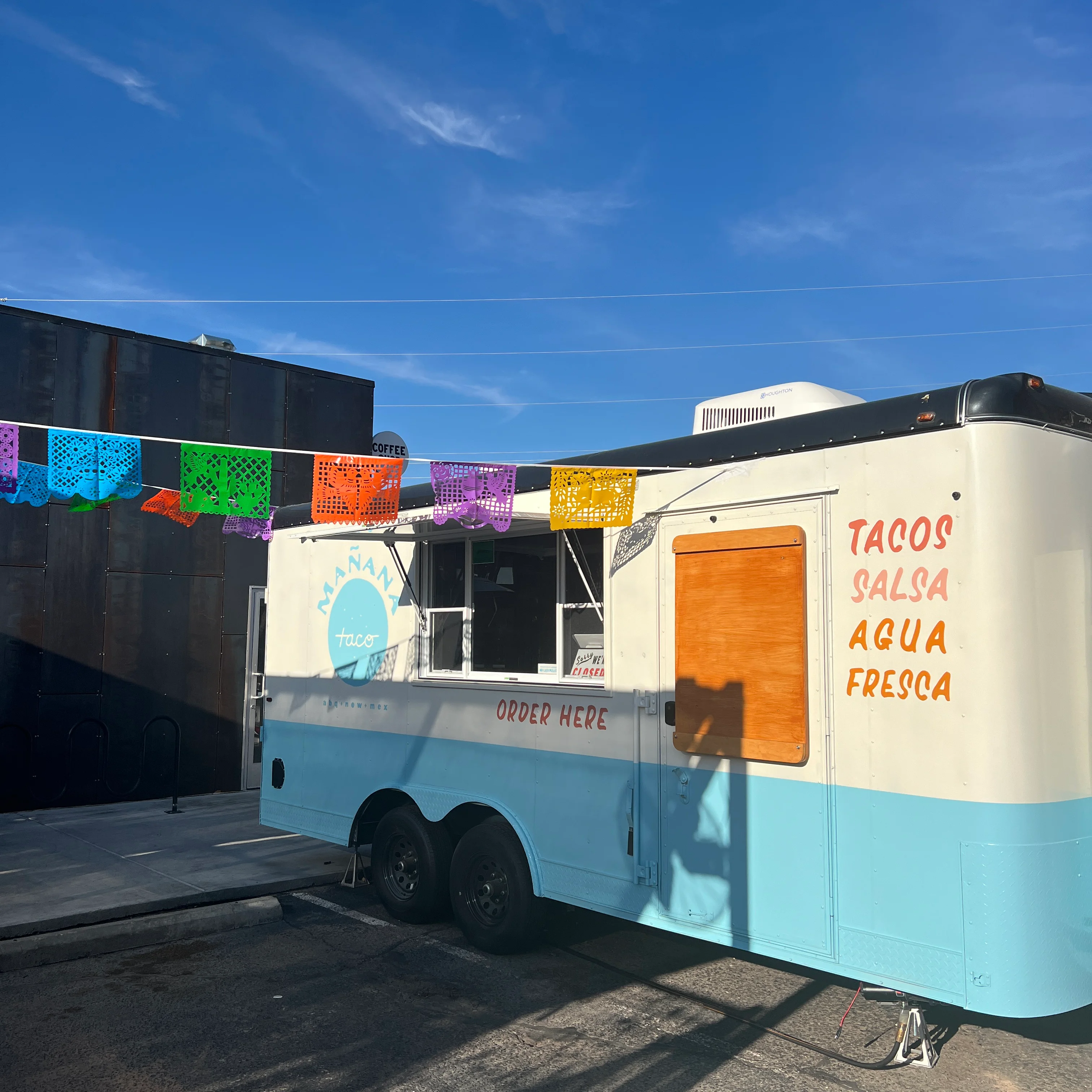 Colorful taco truck with vibrant papel picado banners