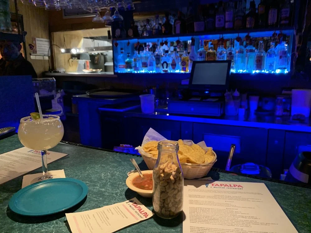 Cozy bar scene with cocktails and snacks at a Mexican restaurant