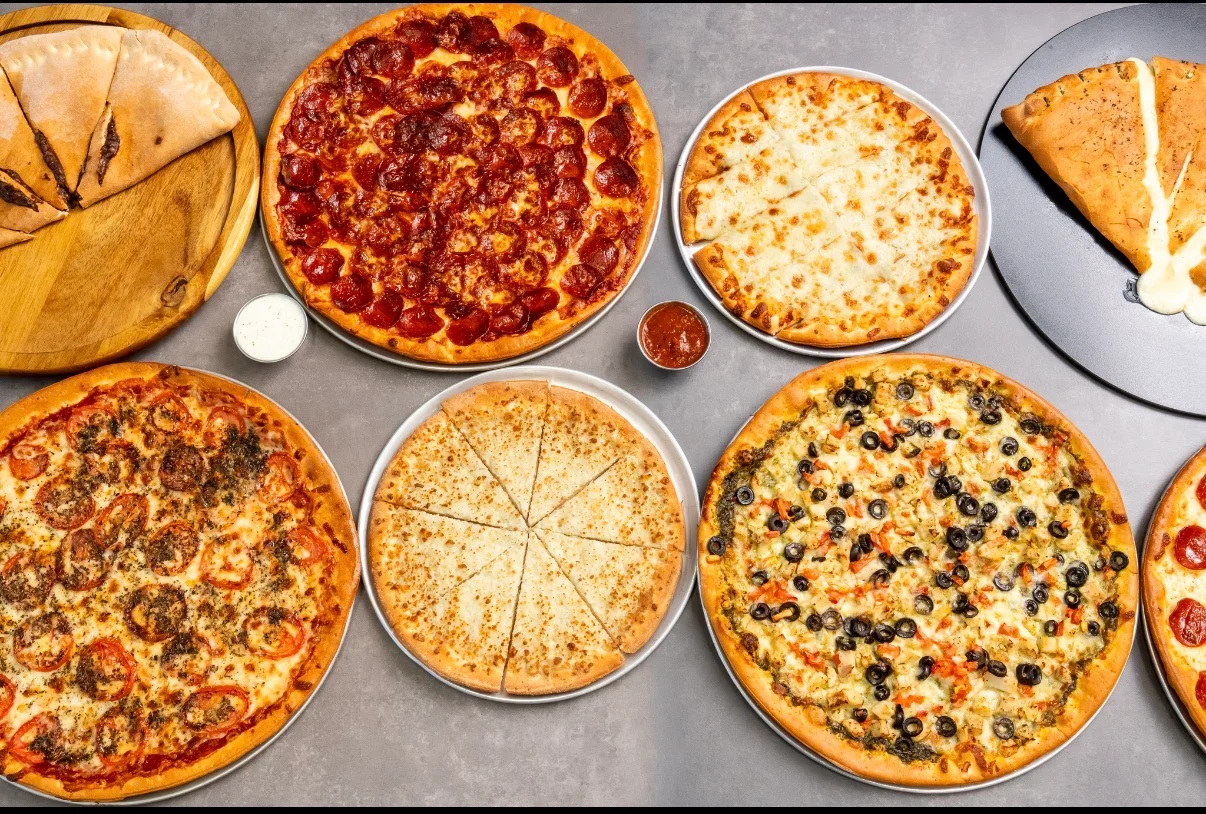Variety of pizzas including pepperoni and vegetarian styles