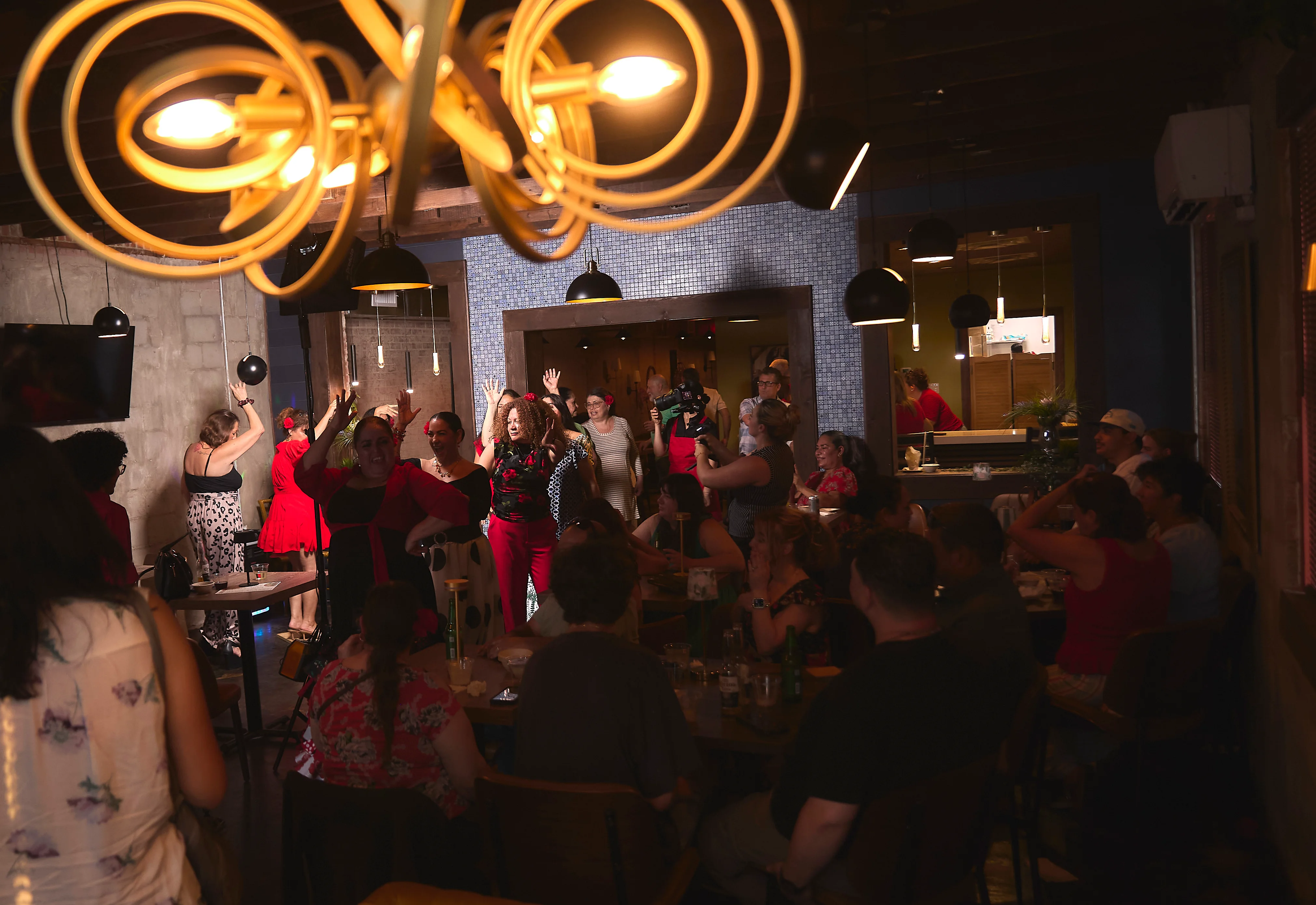 Vibrant restaurant interior with lively guests enjoying a celebration