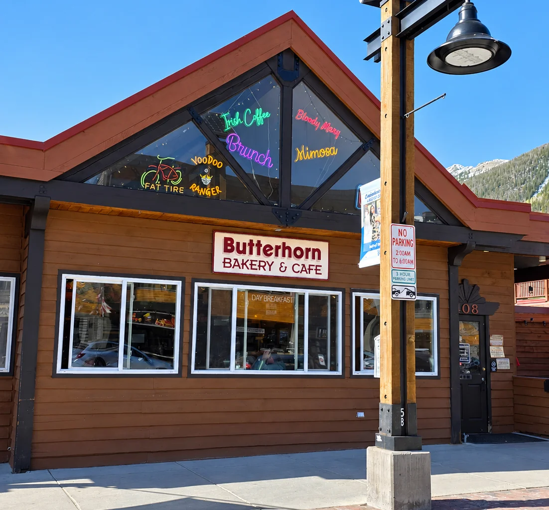 Charming street view of a bakery and café with mountain backdrop