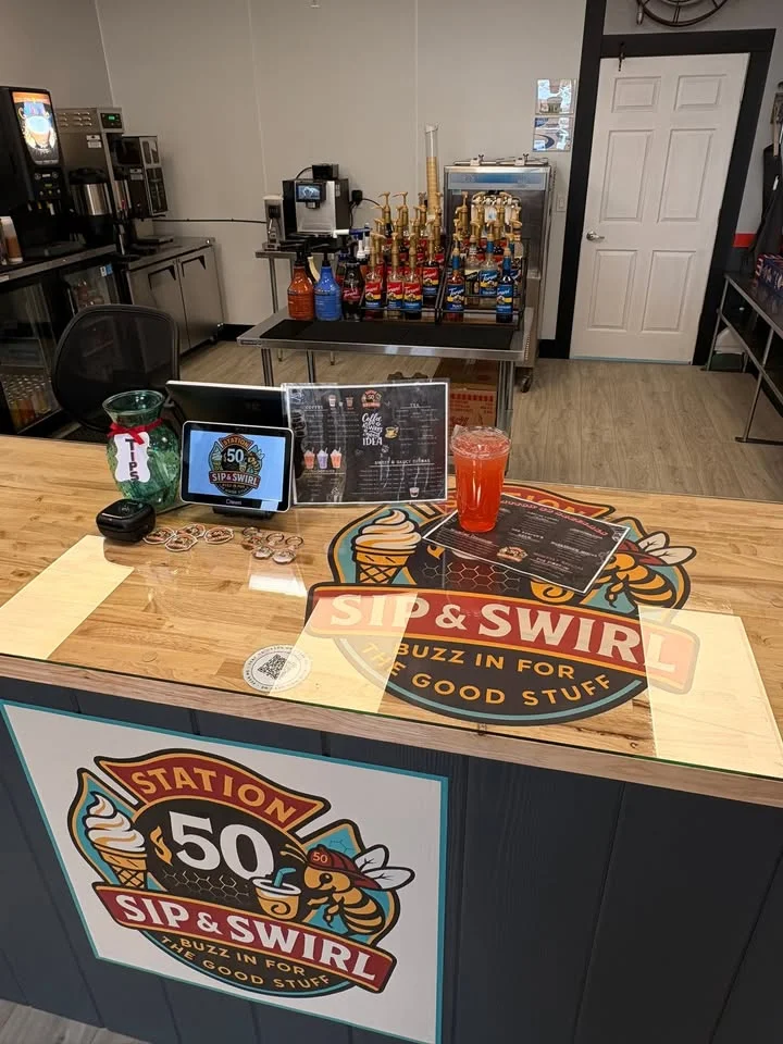 A menu board featuring sodas, malts, milkshakes, and syrup flavors available at a beverage shop.