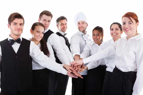 Restaurant staff team posing together with enthusiasm