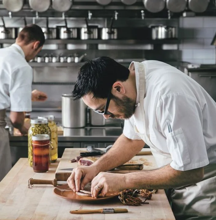 A restaurant chef preparing a dish