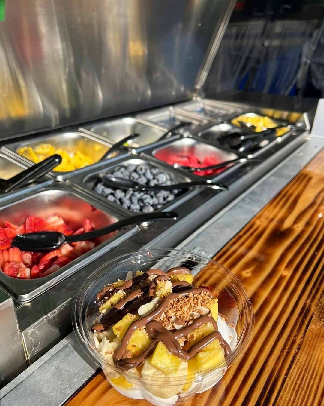 Tropical fruit bowl with chocolate drizzle and nuts