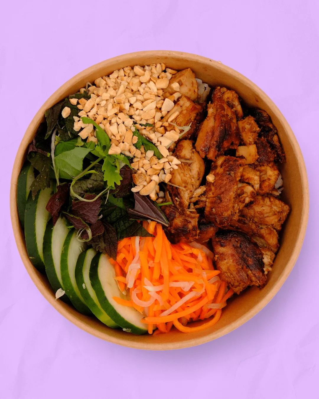 Vietnamese rice bowl with grilled chicken and fresh vegetables