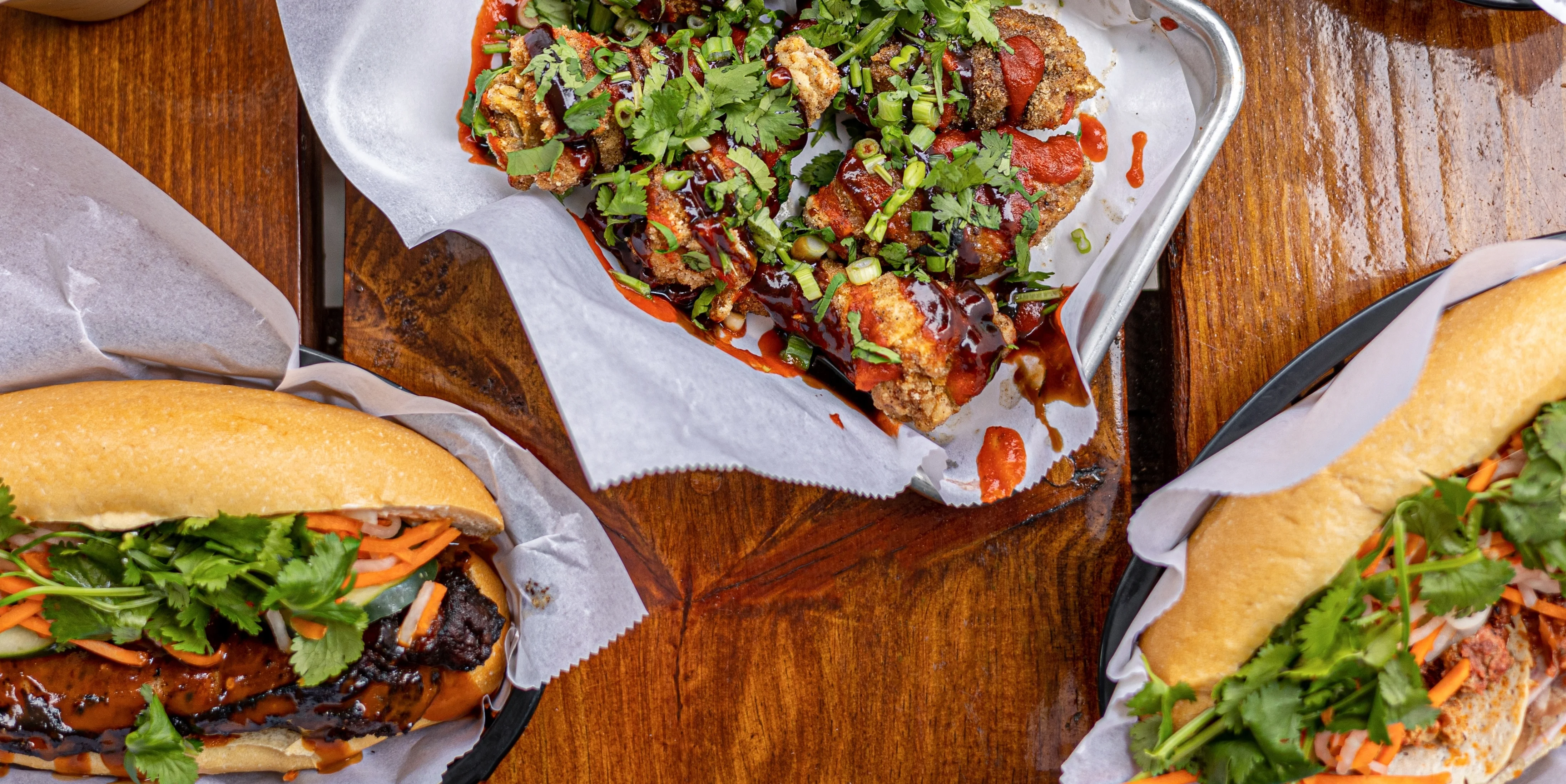 Delicious hot dogs and crispy snacks topped with herbs and sauces.