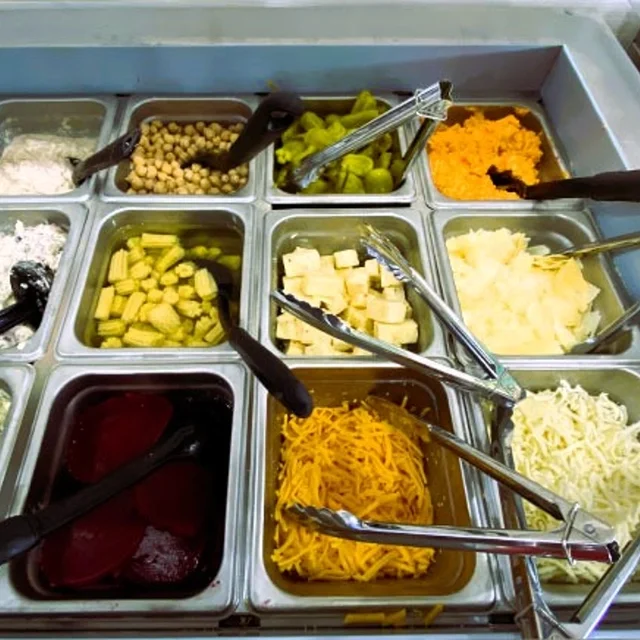 Colorful salad bar with various toppings and dressings