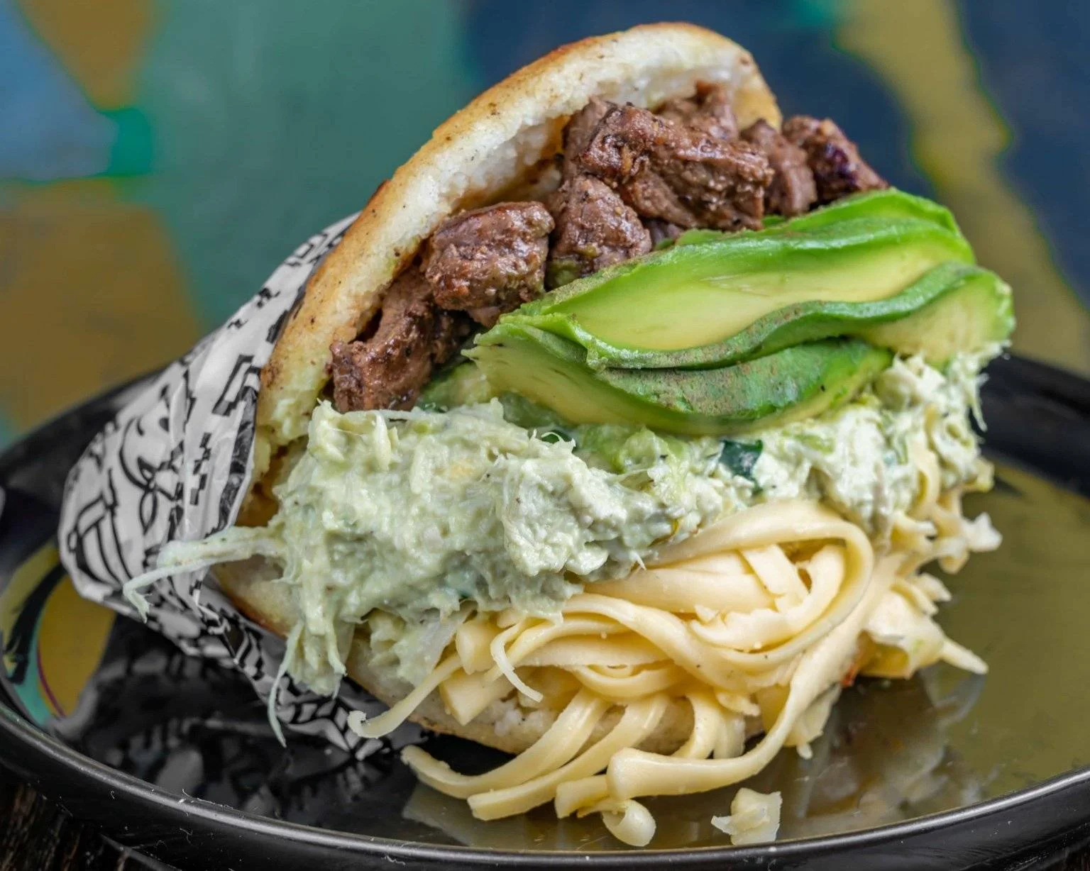 Venezuelan arepa filled with beef and avocado