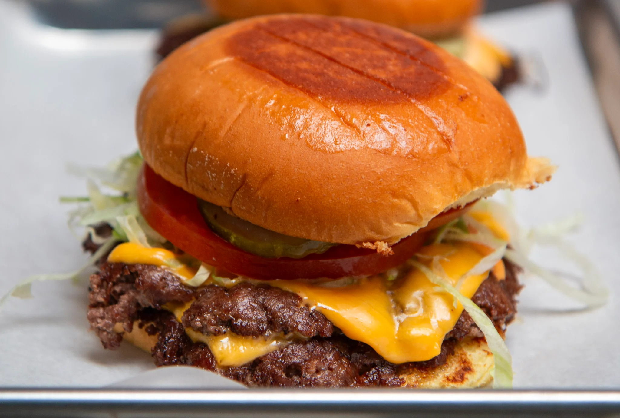 Juicy cheeseburger with lettuce and tomato