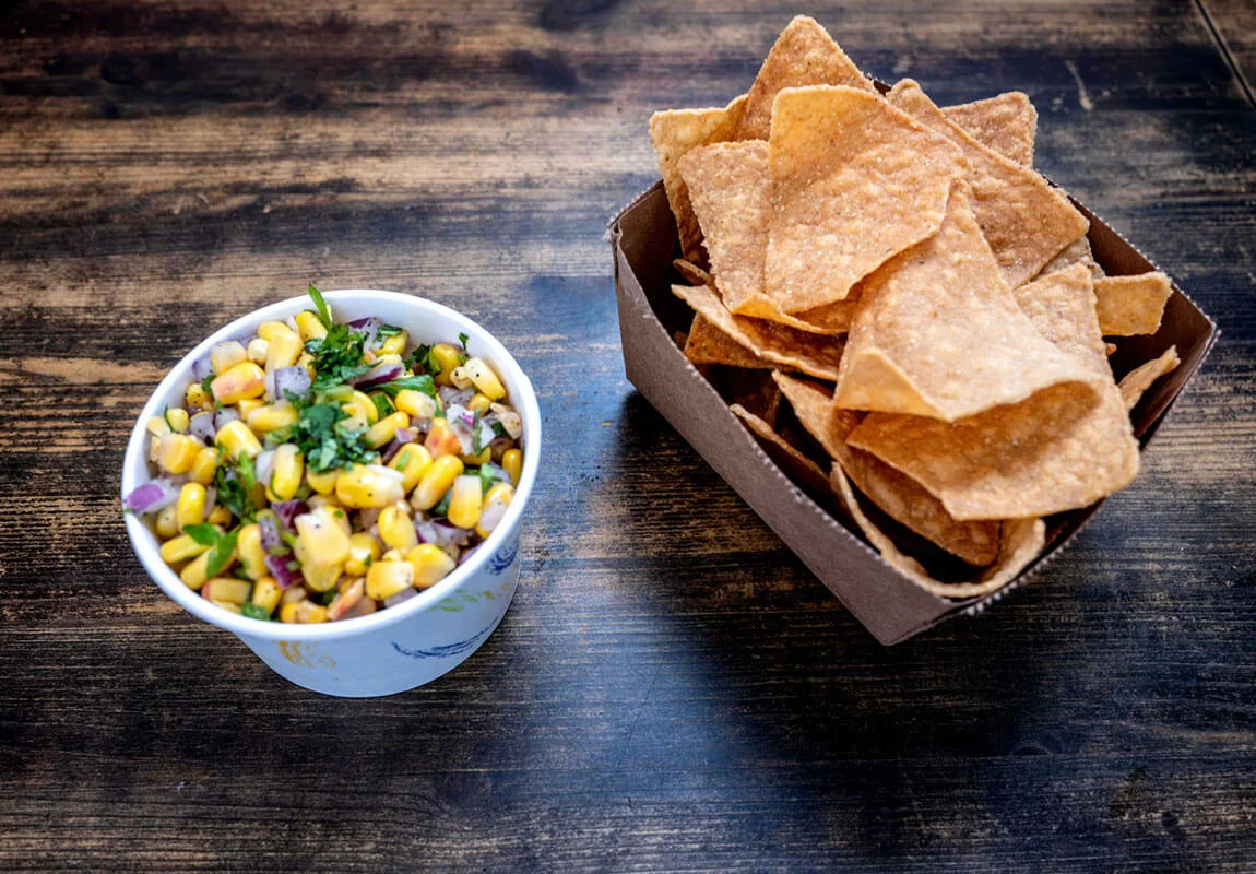 Fresh corn salsa with tortilla chips, a popular Mexican appetizer