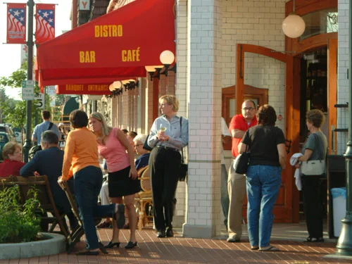 Outdoor dining scene at a bistro with patrons enjoying their meals