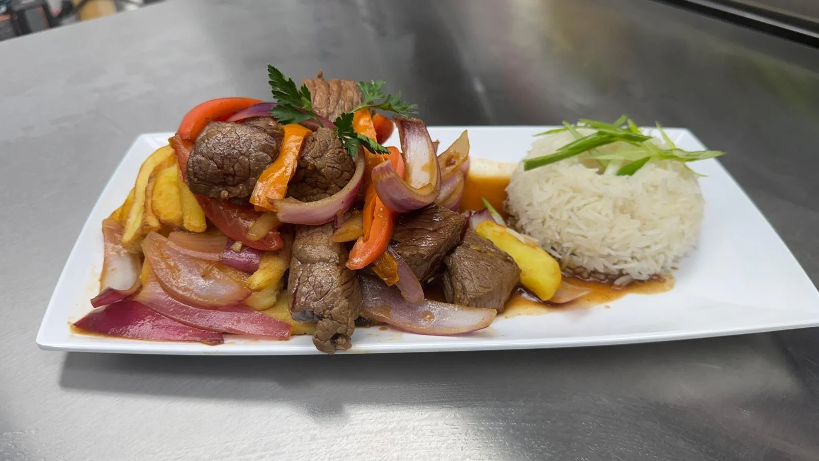 Peruvian lomo saltado with rice and vegetables