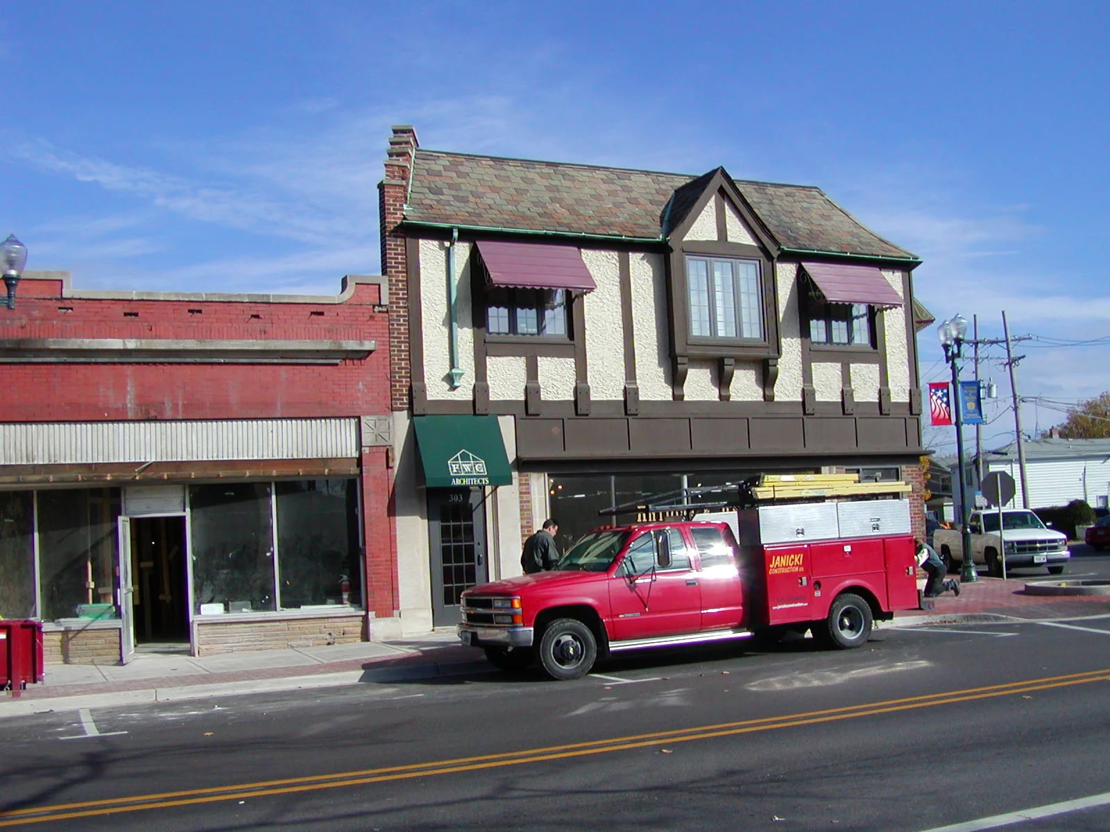 Charming building exterior with a red truck parked in front
