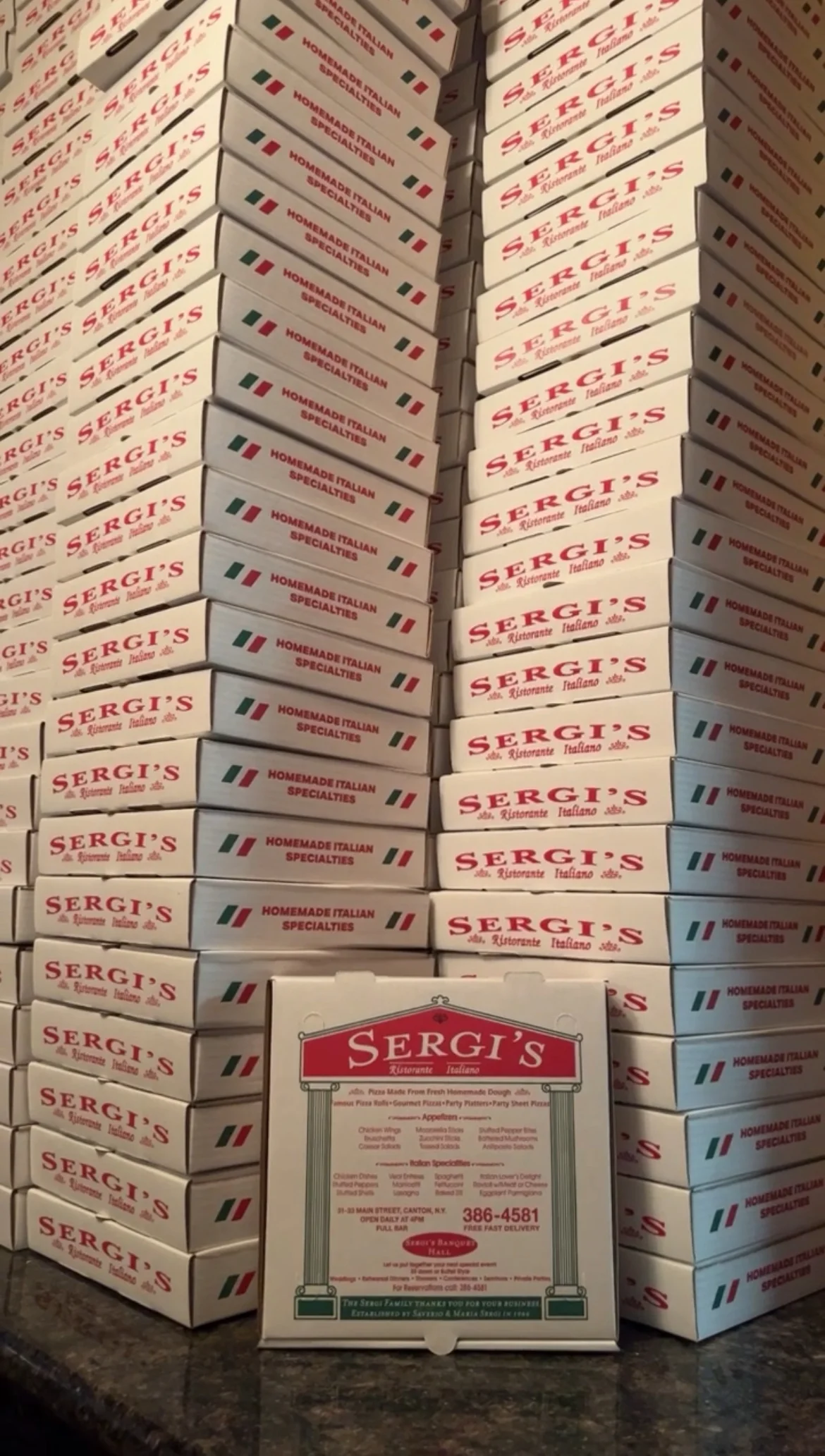 Stacked pizza boxes from Sergi's Italian restaurant
