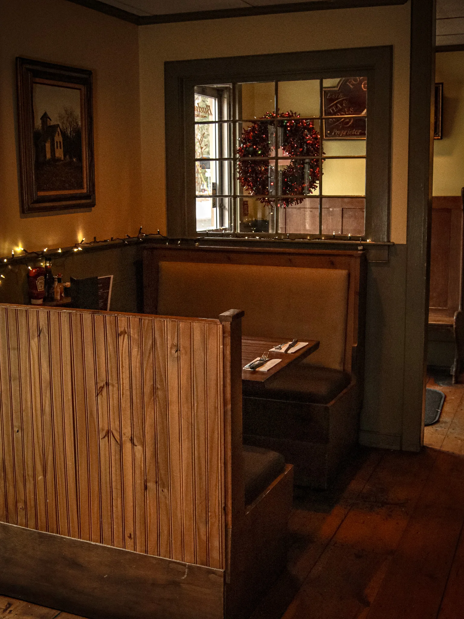 Cozy restaurant booth with warm lighting and holiday decor