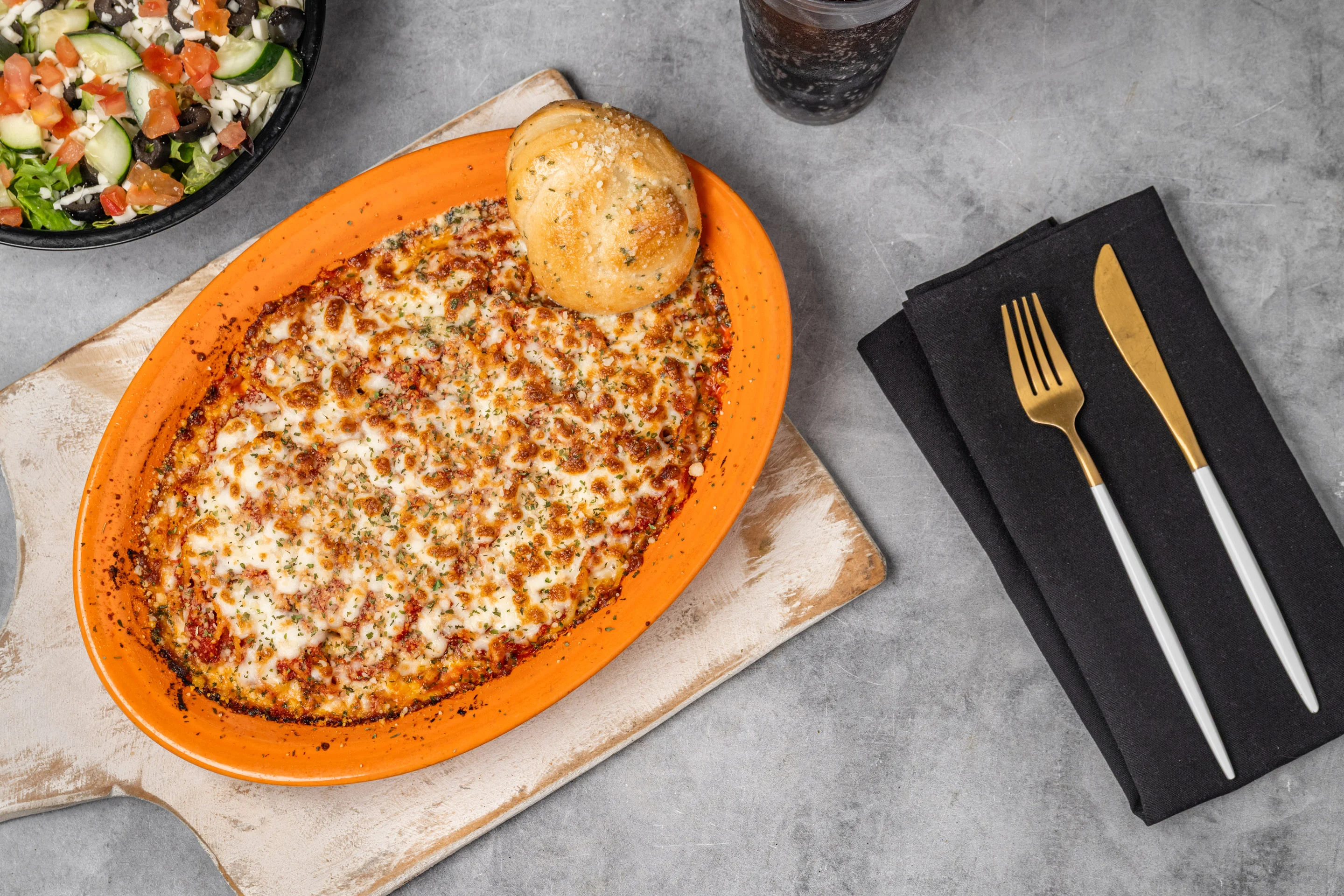 Baked Italian lasagna with cheese and garlic bread