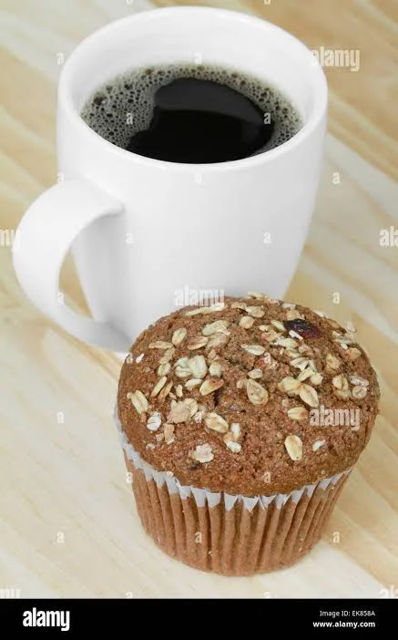 Freshly baked oatmeal muffin with a cup of black coffee